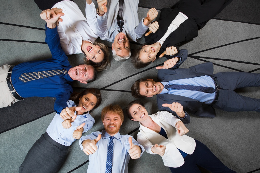 business-people-lying-floor-showing-thumbs-up.jpg