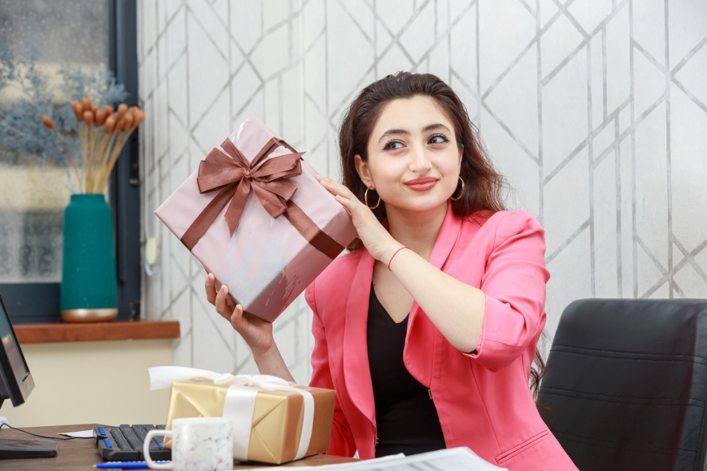 young-businesswoman-holding-present-box-high-quality-photo.jpg