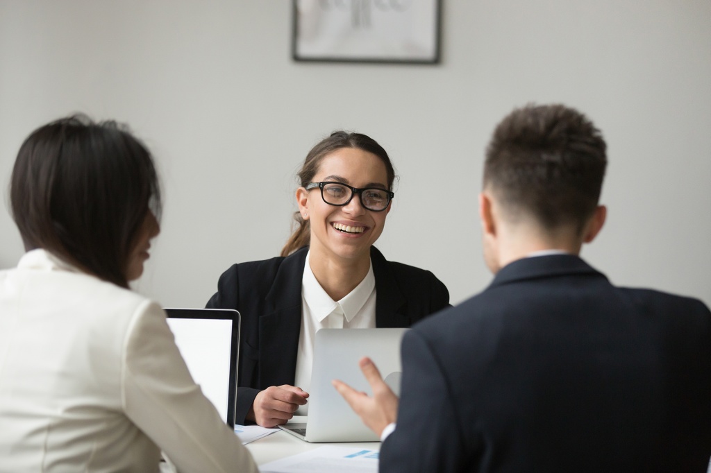 smiling-businesswoman-talking-with-subordinated-about-reports.jpg