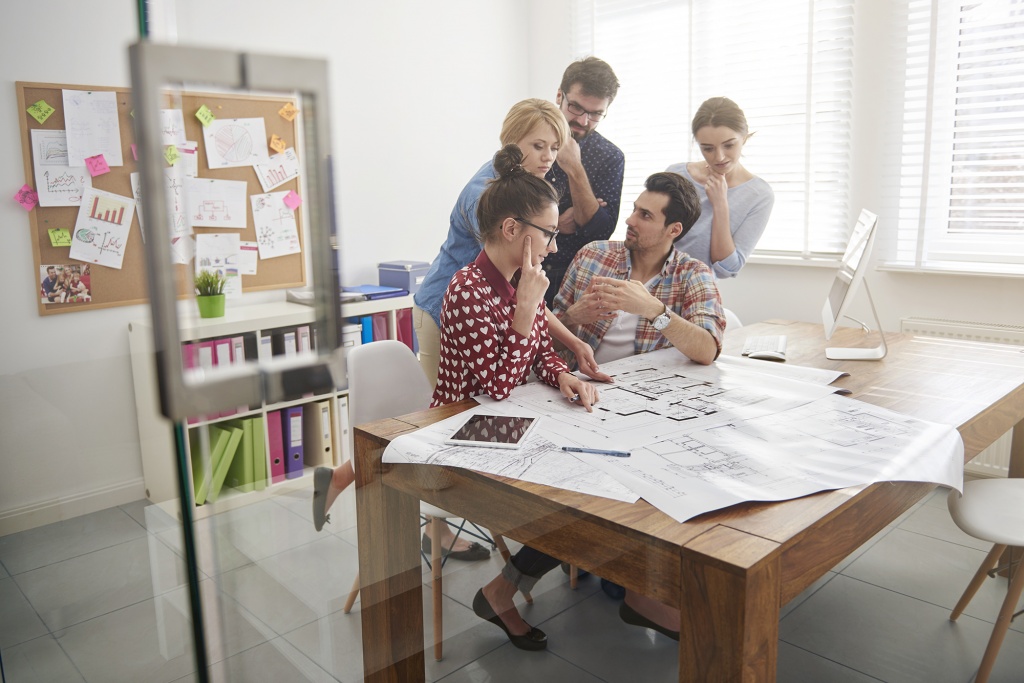 coworkers-office-with-architecture-plans-computer.jpg