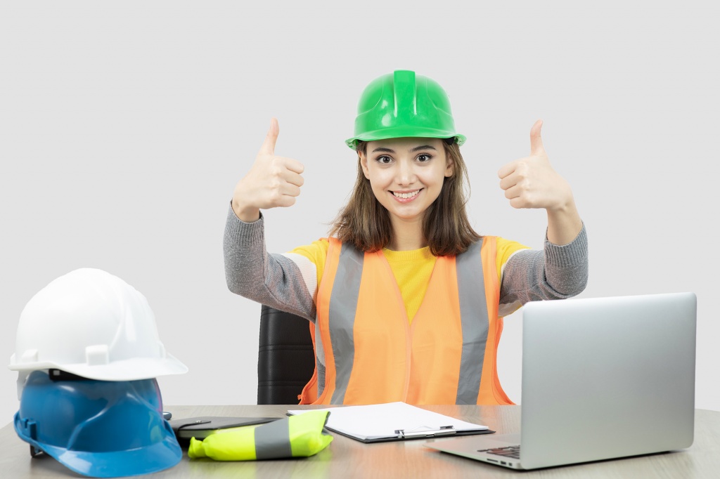 worker-female-in-uniform-sitting-at-the-desk-and-showing-thumbs-up-high-quality-photo.jpg