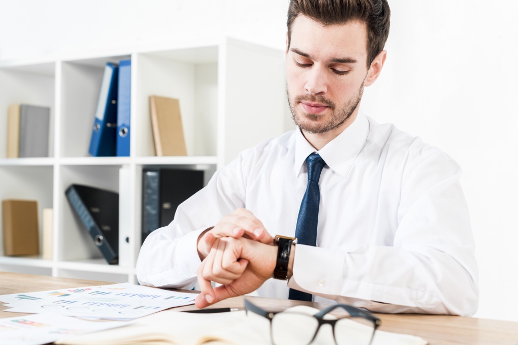 young-businessman-workplace-watching-time-wrist-watch.jpg