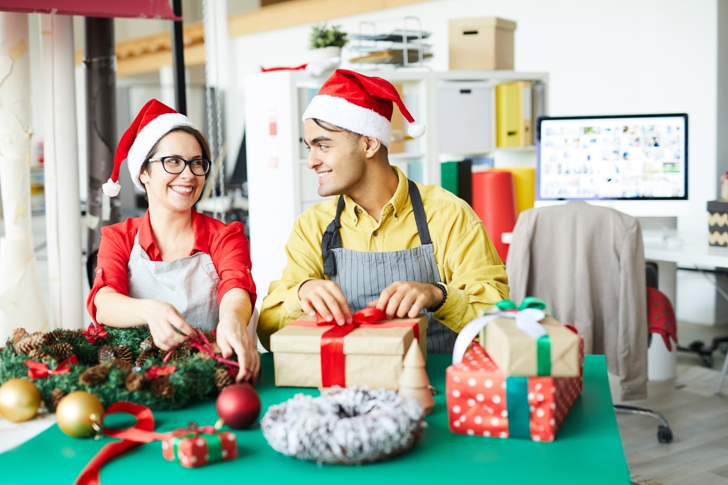 colleagues-preparing-christmas-decoration-and-wrapping-presents5.jpg