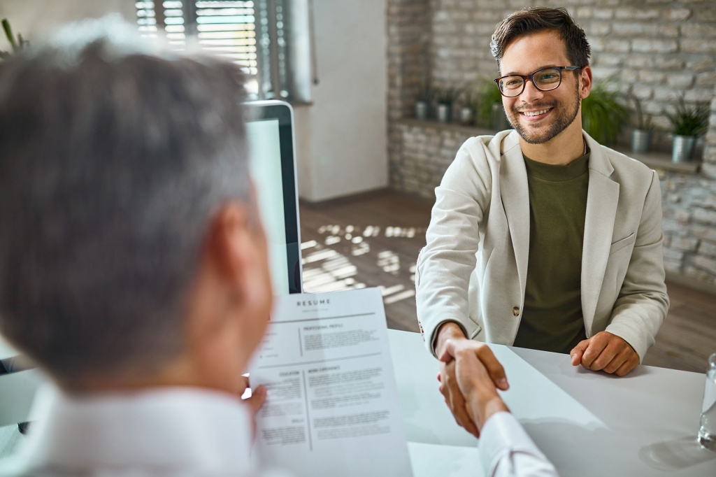 happy-male-candidate-greeting-member-human-resource-team-job-interview-office.jpg